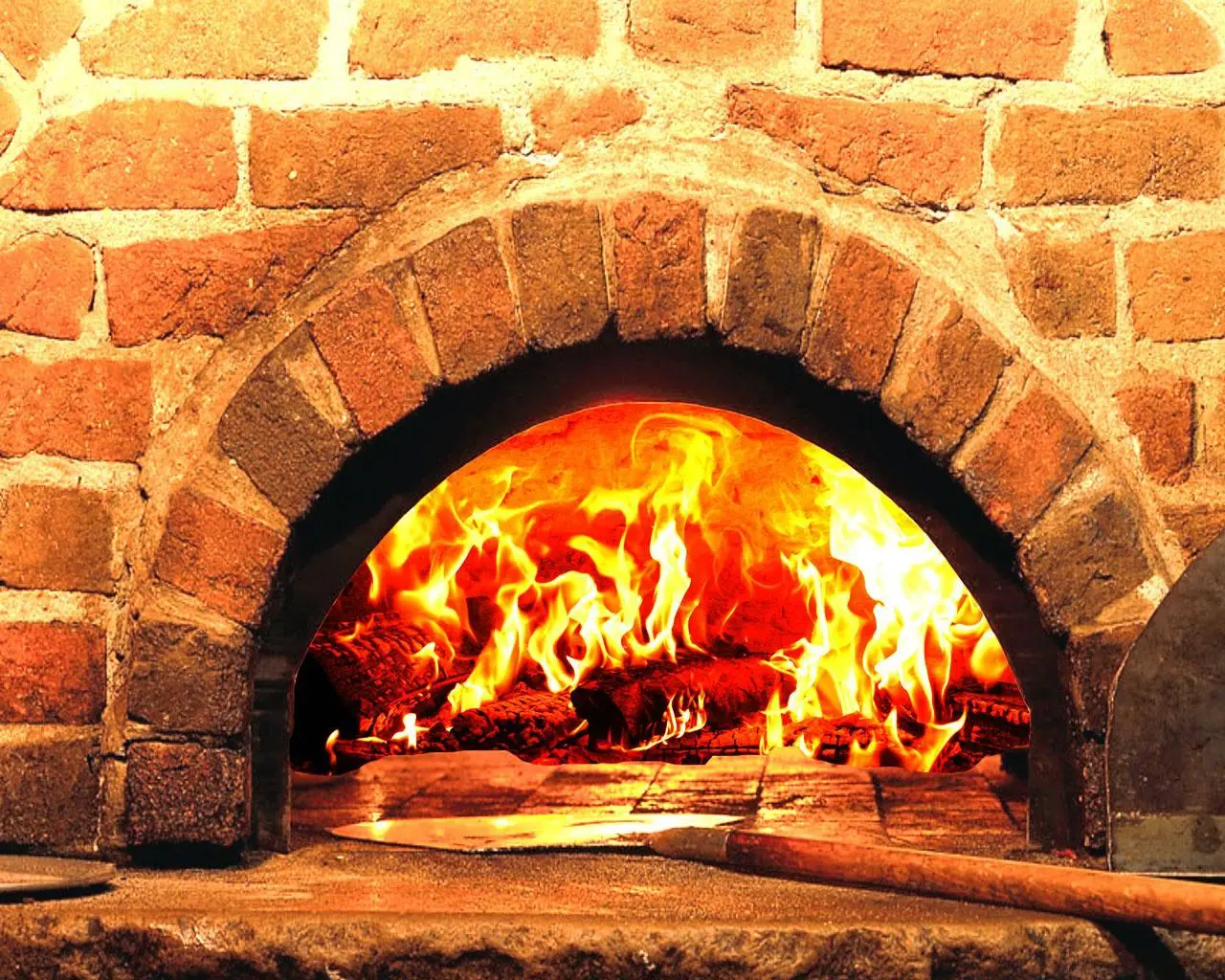 A wood fire burning in the stone oven